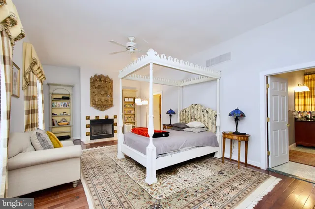 a bathroom with a sink a toilet and a large mirror