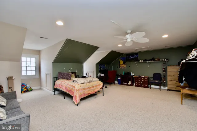 a view of a livingroom with wooden floor and windows