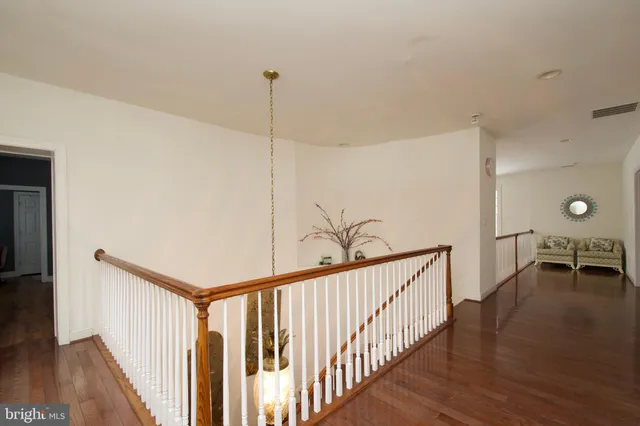 a bedroom with furniture and wooden floor