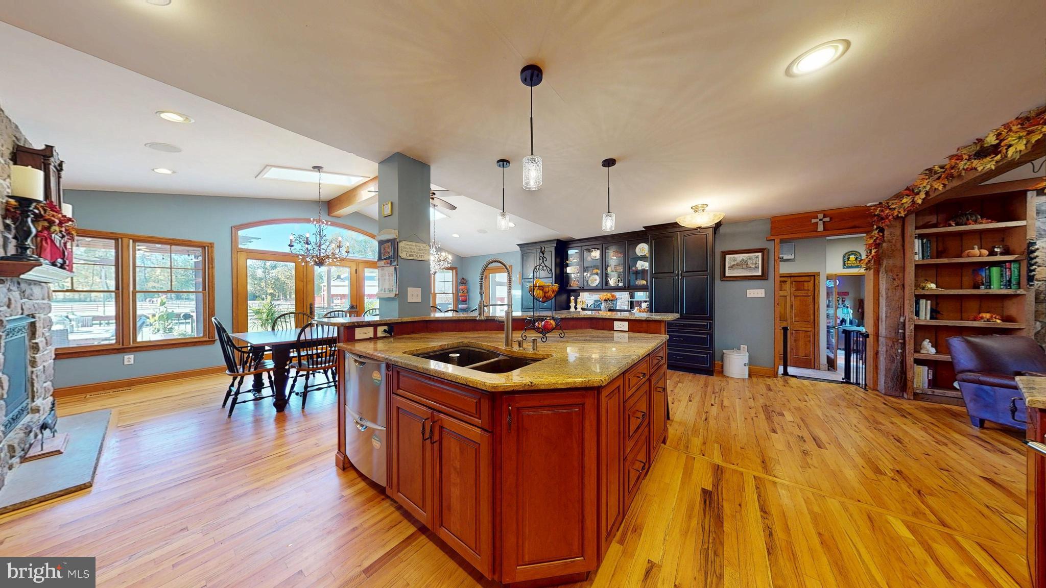40 Cooper Tomlinson Road Medford, NJ 08055 - Photo 19 of 96 a kitchen with stainless steel appliances granite countertop a table and chairs in it
