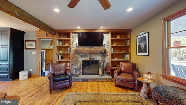 a living room with furniture and a floor to ceiling window