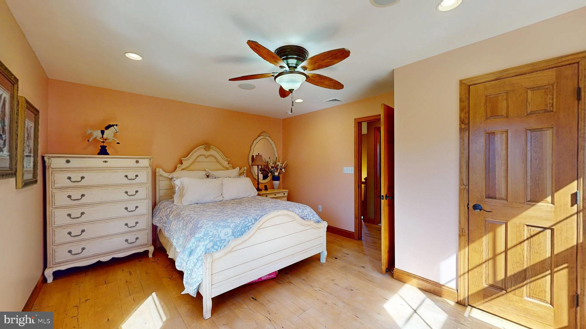 40 Cooper Tomlinson Road Medford, NJ 08055 - Photo 65 of 96 a bedroom with a bed and a chandelier