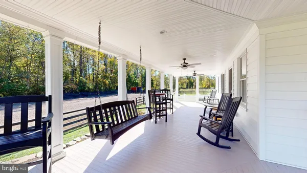 a view of a chairs and table in the balcony