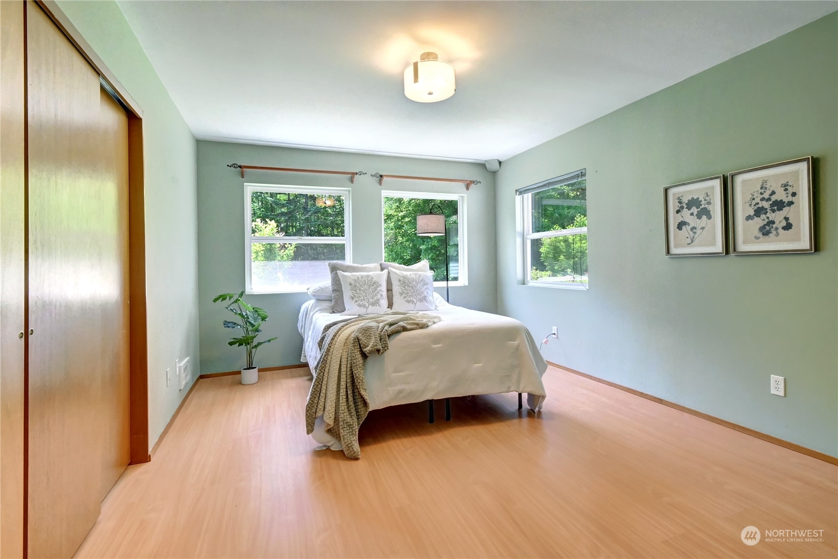 12515 Chain Lake Road Snohomish, WA 98290 - Photo 15 of 37 a bed sitting in a spacious bedroom next to a window