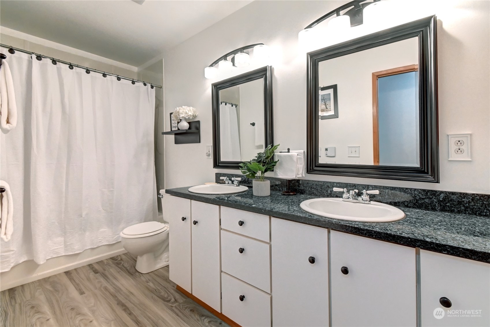 12515 Chain Lake Road Snohomish, WA 98290 - Photo 17 of 37 a bathroom with a granite countertop sink and a mirror