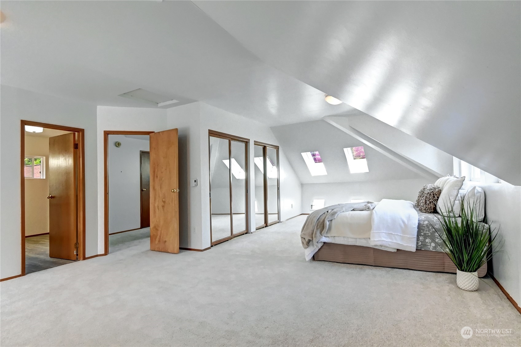 12515 Chain Lake Road Snohomish, WA 98290 - Photo 21 of 37 a spacious bedroom with a bed and lamp