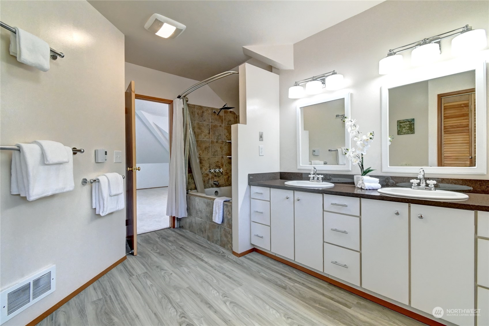 12515 Chain Lake Road Snohomish, WA 98290 - Photo 22 of 37 a spacious bathroom with a double vanity sink and a mirror