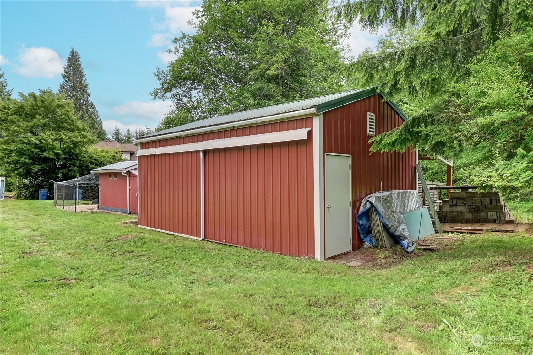 12515 Chain Lake Road Snohomish, WA 98290 - Photo 33 of 37 a view of backyard with potted plants and a large tree
