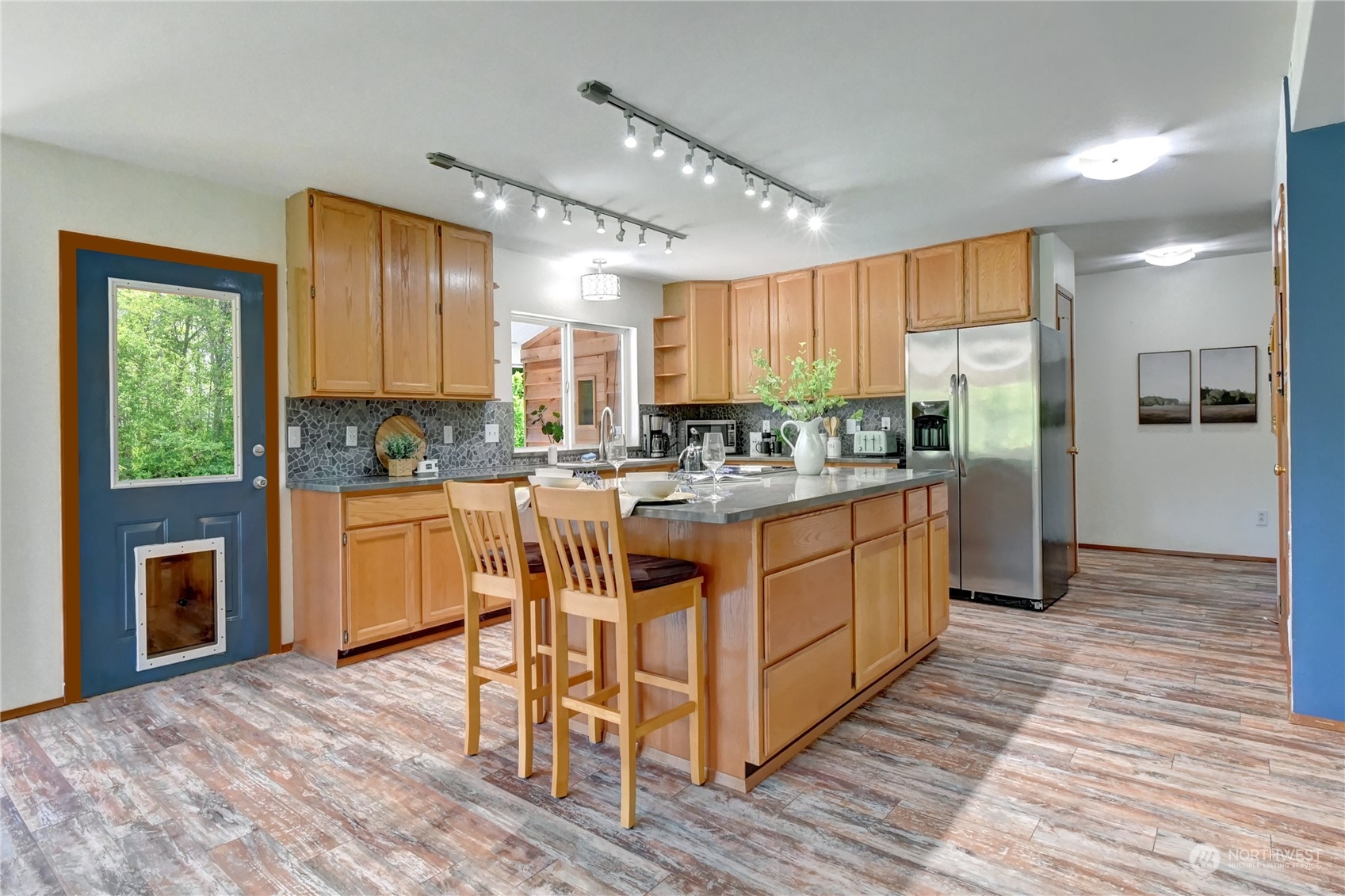 12515 Chain Lake Road Snohomish, WA 98290 - Photo 8 of 37 a kitchen with stainless steel appliances granite countertop a stove a sink a refrigerator and a cabinets