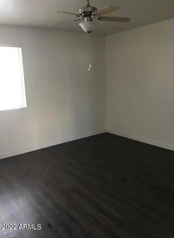 a view of a room with wooden floor and a window