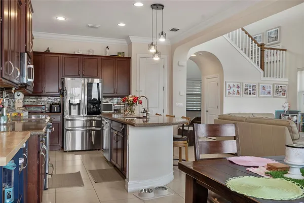 a kitchen with refrigerator and chairs