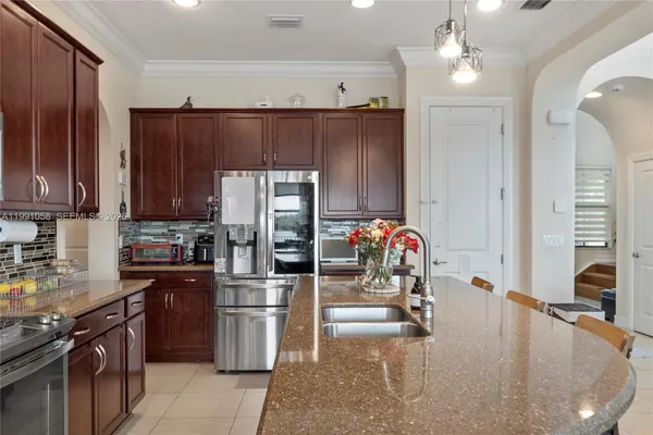 a kitchen with stainless steel appliances granite countertop a sink stove and refrigerator
