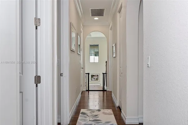 a view of a hallway with a wooden door