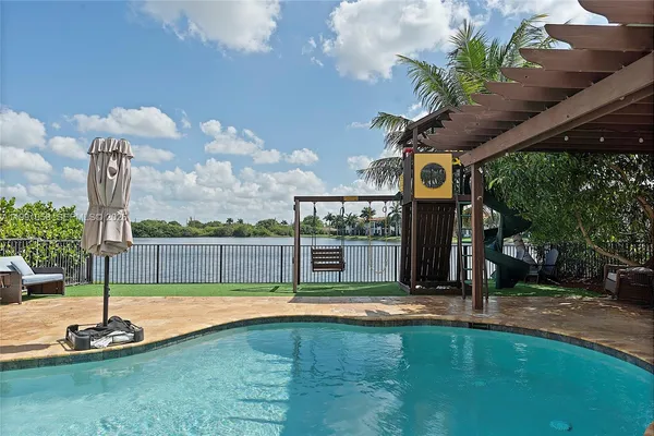 a swimming pool with outdoor seating and yard