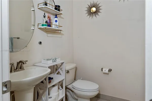 a bathroom with a sink a toilet and a mirror