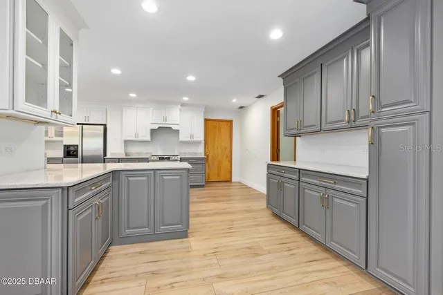 a kitchen with granite countertop a sink and cabinets