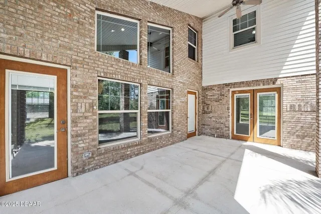 a view of a brick house with large windows