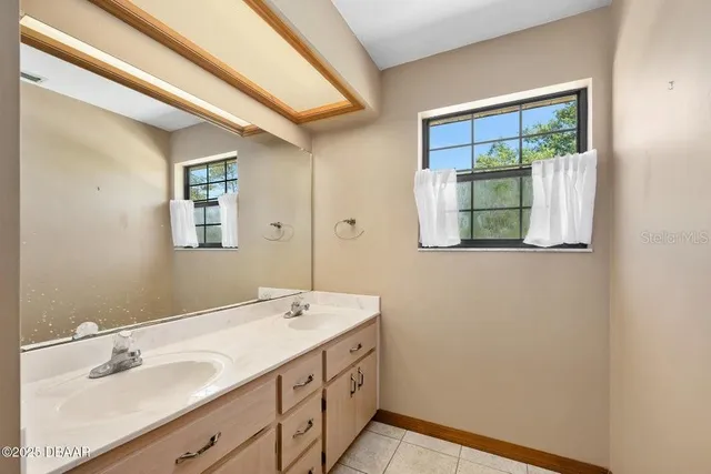 a bathroom with a double vanity sink and a mirror