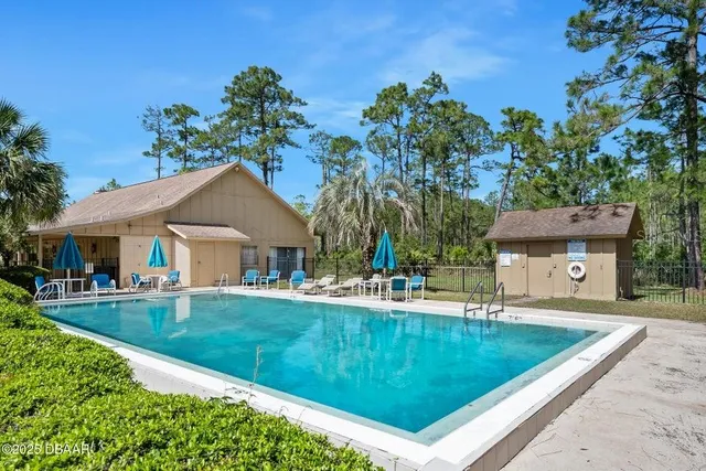 an aerial view of lake and residential houses with outdoor space