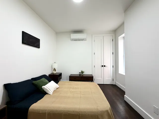 a bedroom with bed and a couch