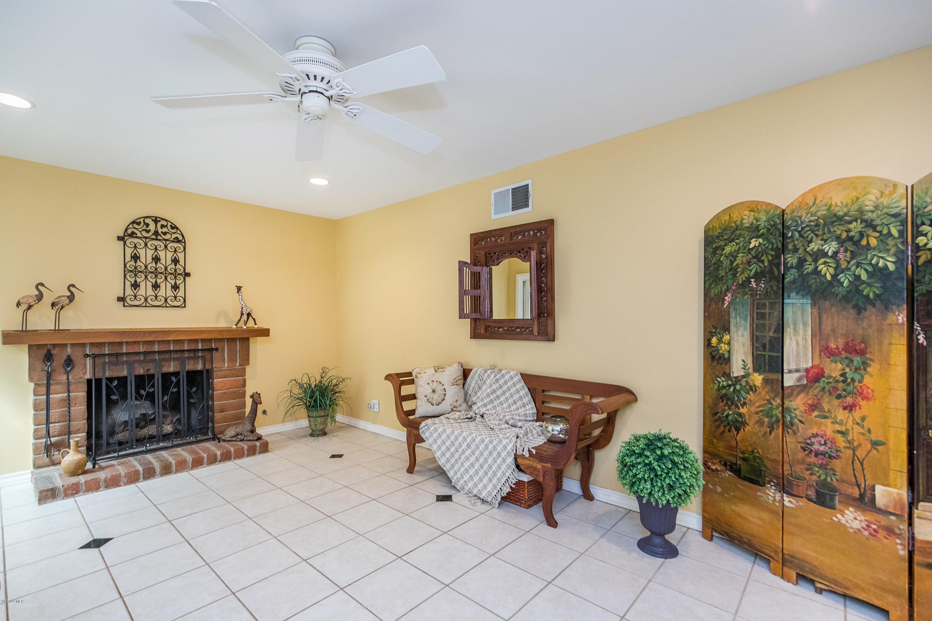 13208 East Quail Summit Road Moorpark, CA 93021 - Photo 12 of 36 a living room with furniture and a fireplace