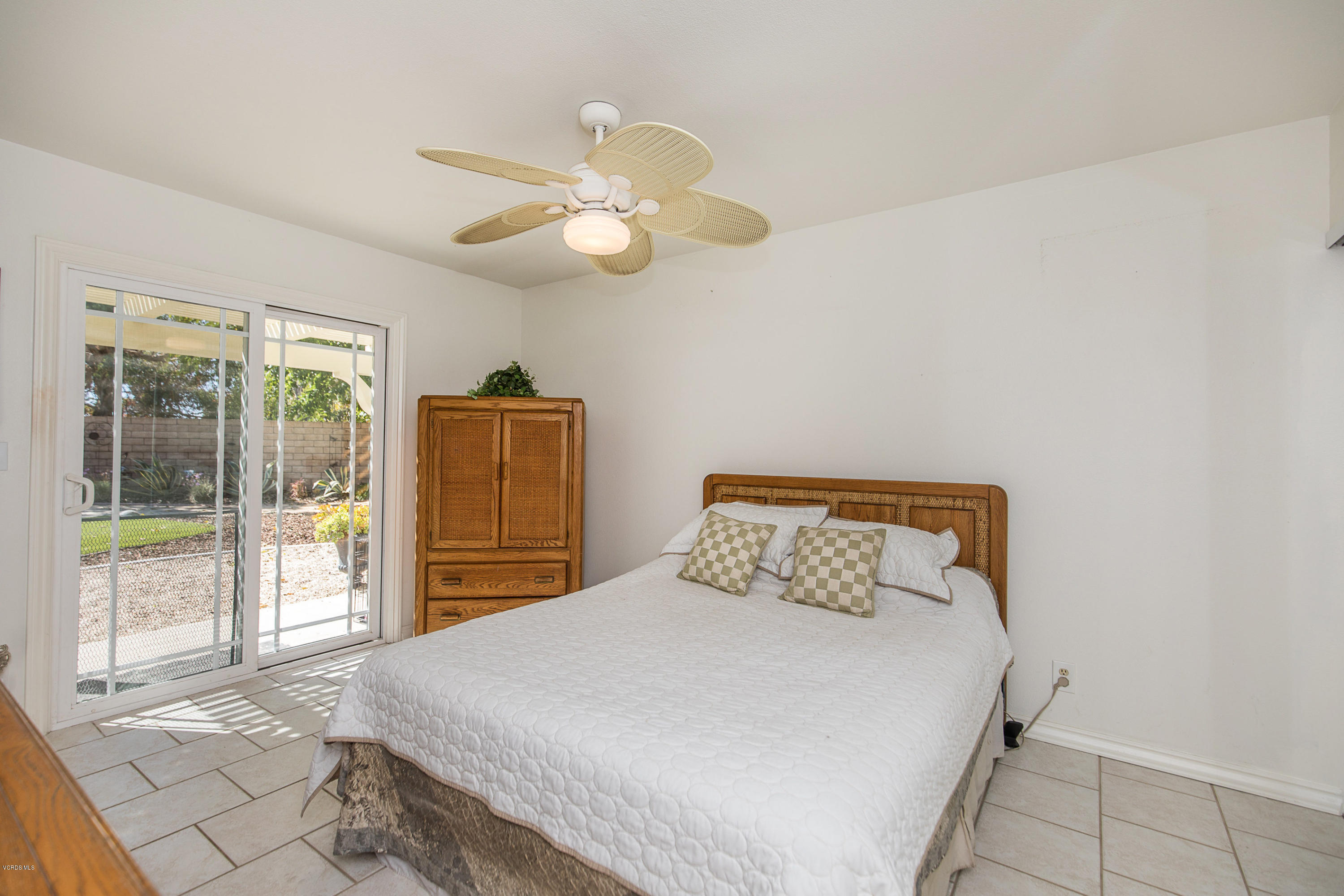 13208 East Quail Summit Road Moorpark, CA 93021 - Photo 16 of 36 a bedroom with a large bed and a chandelier