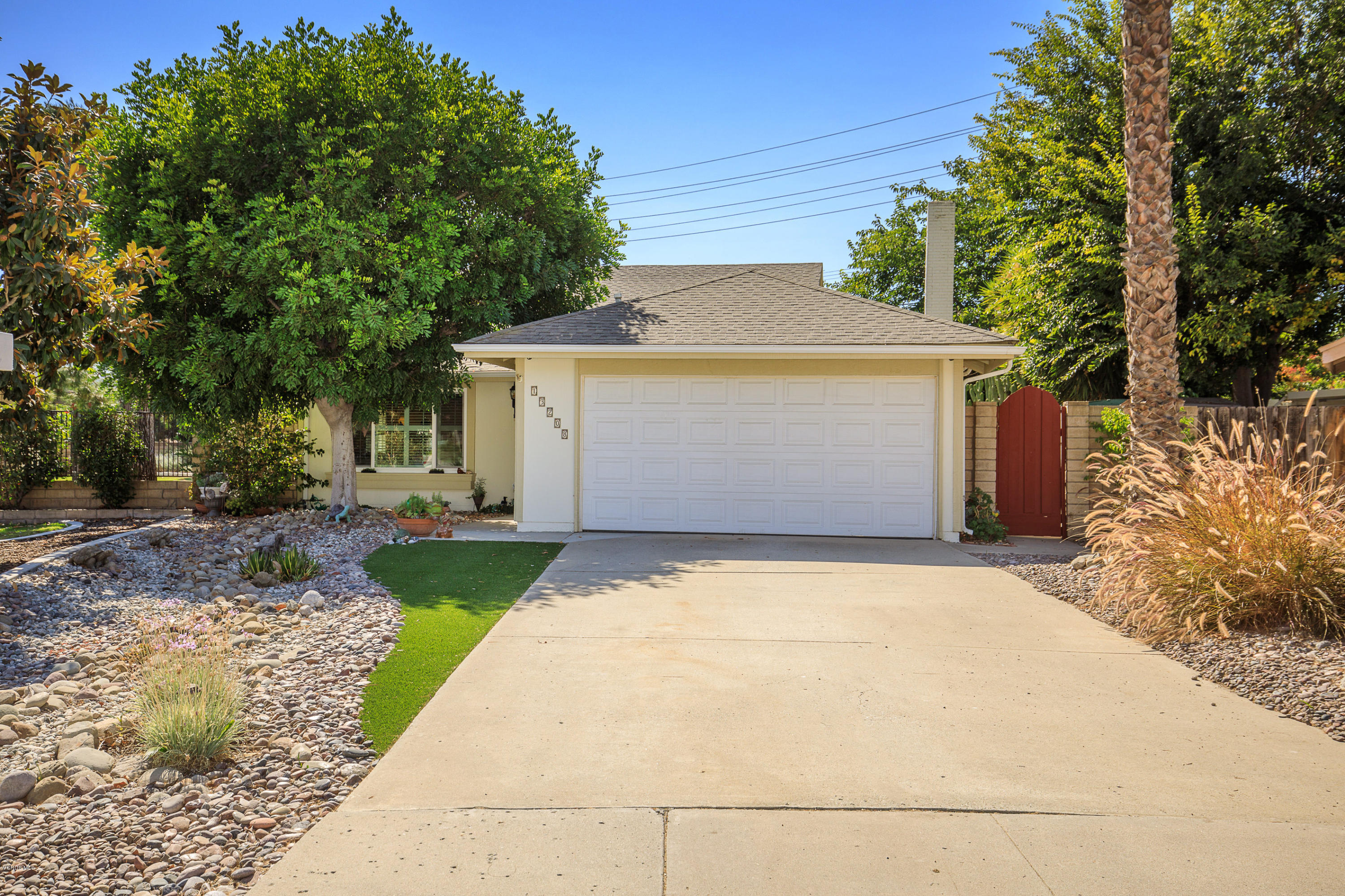 13208 East Quail Summit Road Moorpark, CA 93021 - Photo 3 of 36 a front view of a house with a yard and a garage