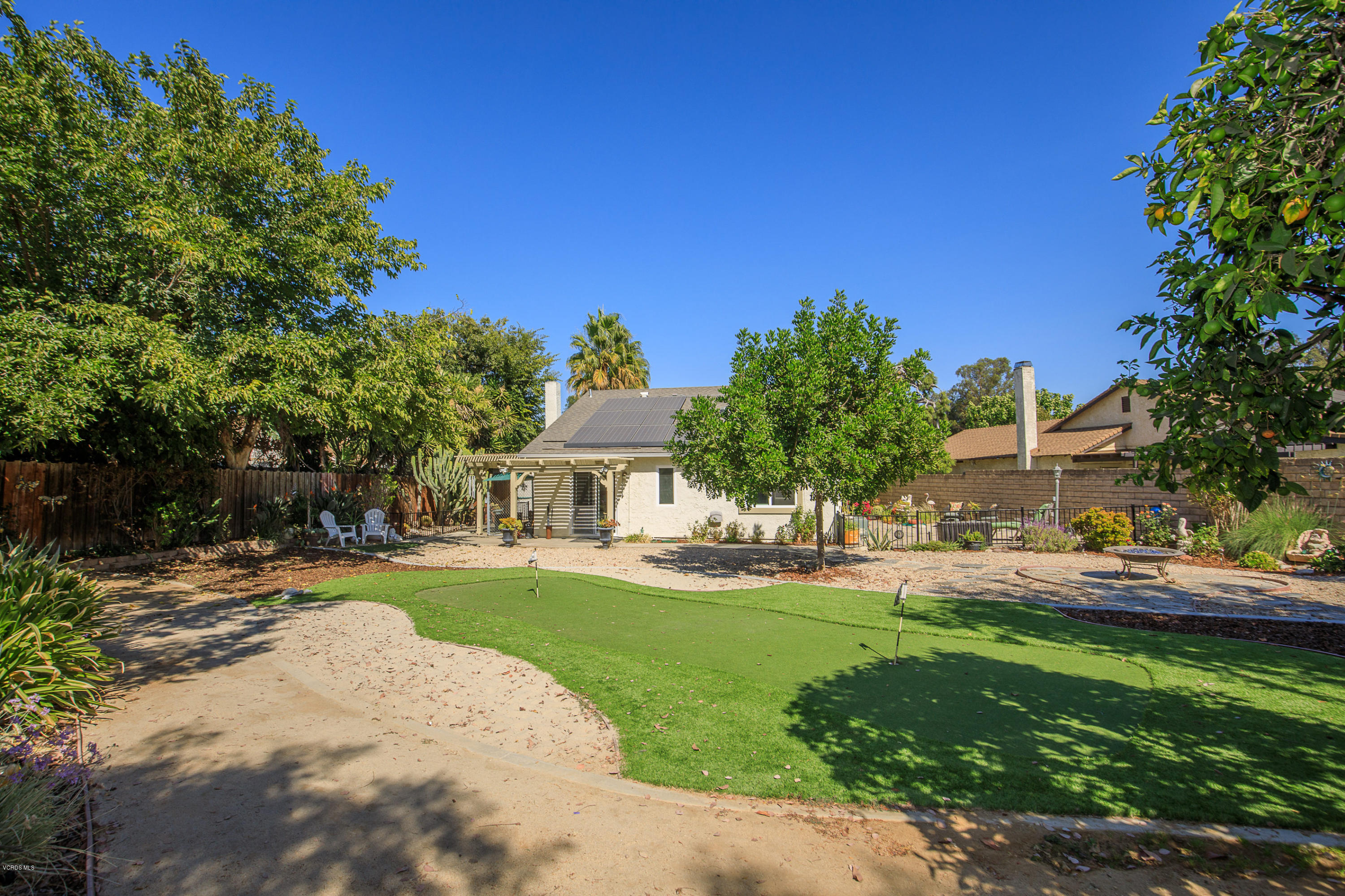 13208 East Quail Summit Road Moorpark, CA 93021 - Photo 22 of 36 a front view of a house with a yard and trees
