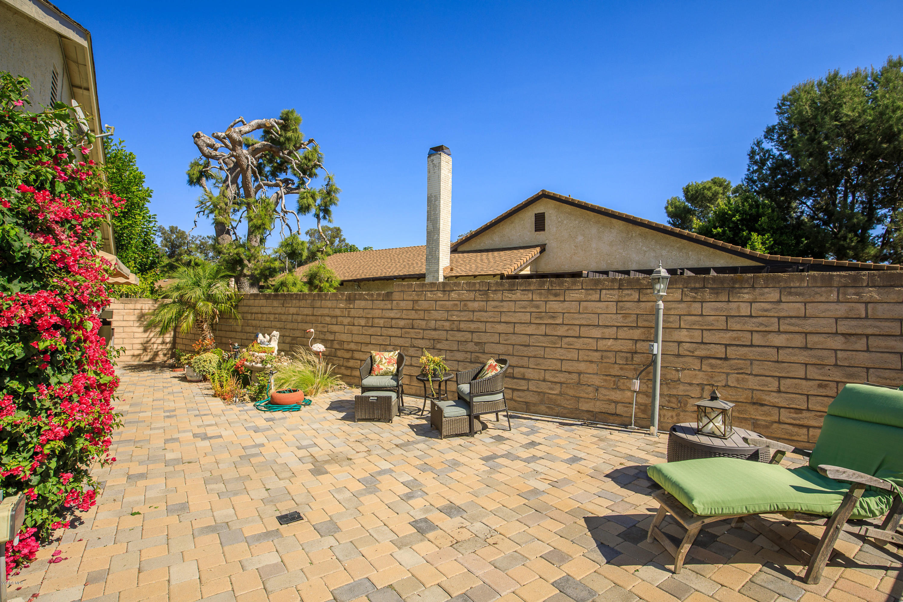 13208 East Quail Summit Road Moorpark, CA 93021 - Photo 26 of 36 a backyard of a house with table and chairs and potted plants
