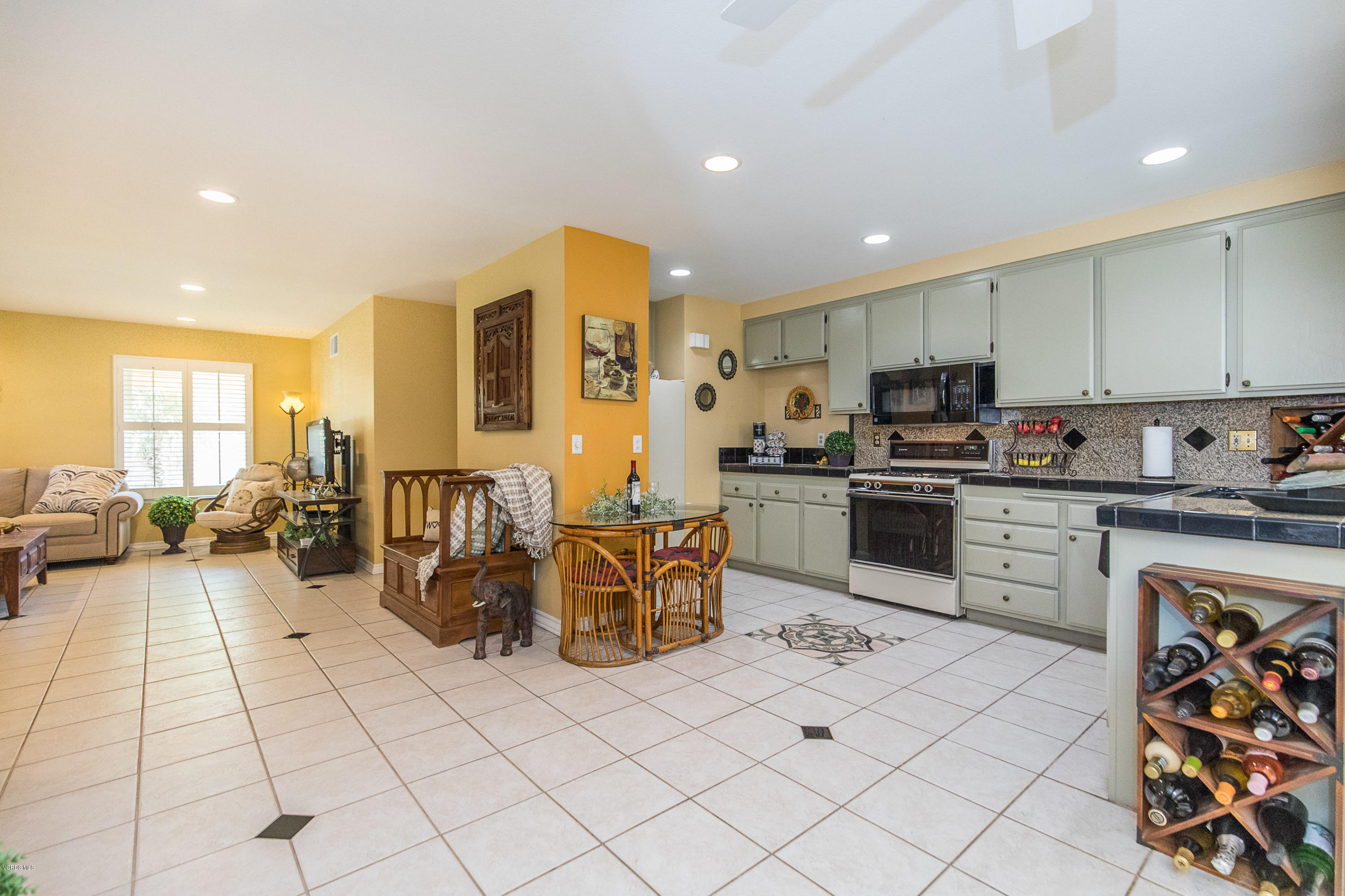 13208 East Quail Summit Road Moorpark, CA 93021 - Photo 10 of 36 a kitchen with stainless steel appliances kitchen island granite countertop a sink and cabinets