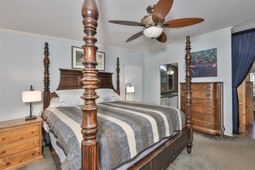 20112 Hobbs Road Wimauma, FL 33598 - Photo 25 of 94 a bed room with a bed and a chandelier