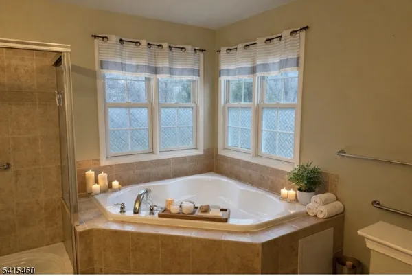 a bath tub sitting in a bathroom next to a window