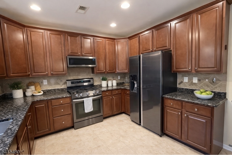 40 Helm's Mill Road Hackettstown, NJ 07840 - Photo 7 of 33 a kitchen with stainless steel appliances granite countertop a stove a refrigerator and a sink