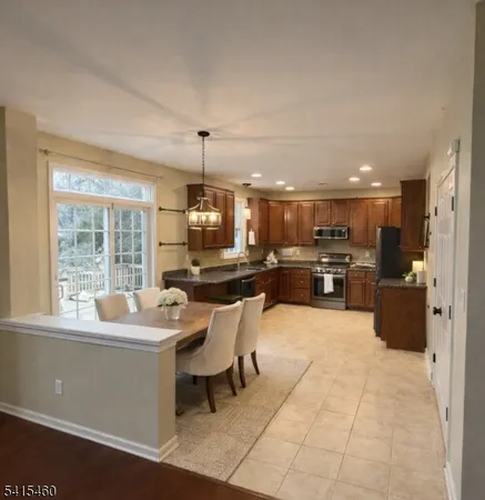 a large kitchen with a table and chairs