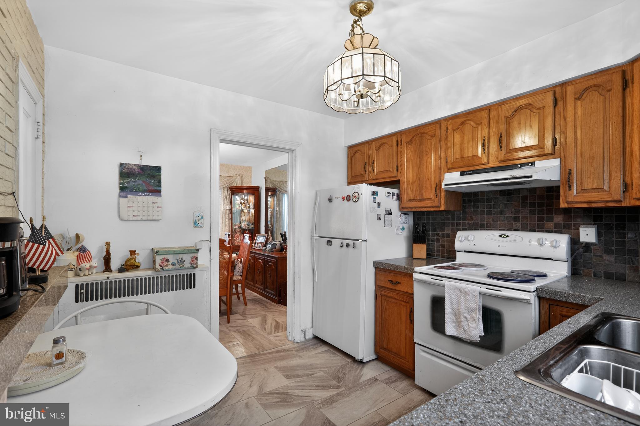 1424 Burmont Road Havertown, PA 19083 - Photo 11 of 37 a kitchen with stainless steel appliances granite countertop a sink stove and refrigerator