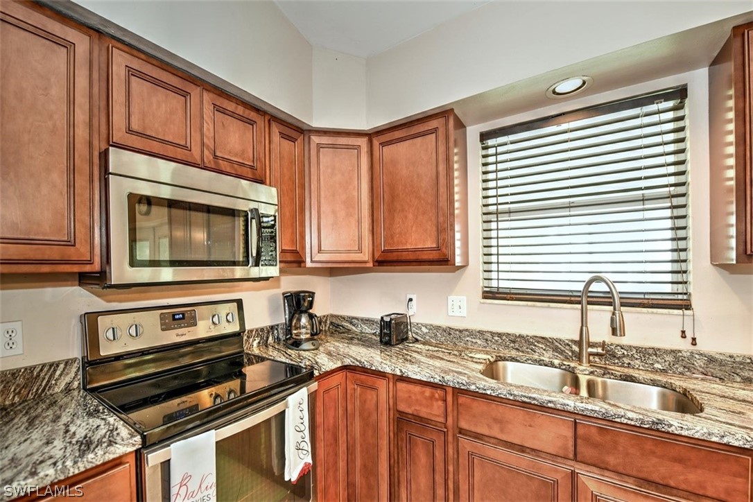 19004 Tangerine Road Fort Myers, FL 33967 - Photo 1 of 26 a kitchen with granite countertop a sink cabinets and window