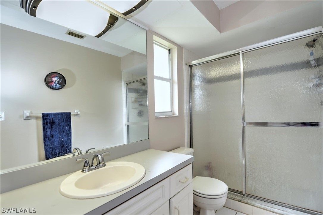 19004 Tangerine Road Fort Myers, FL 33967 - Photo 13 of 26 a bathroom with a sink toilet and shower