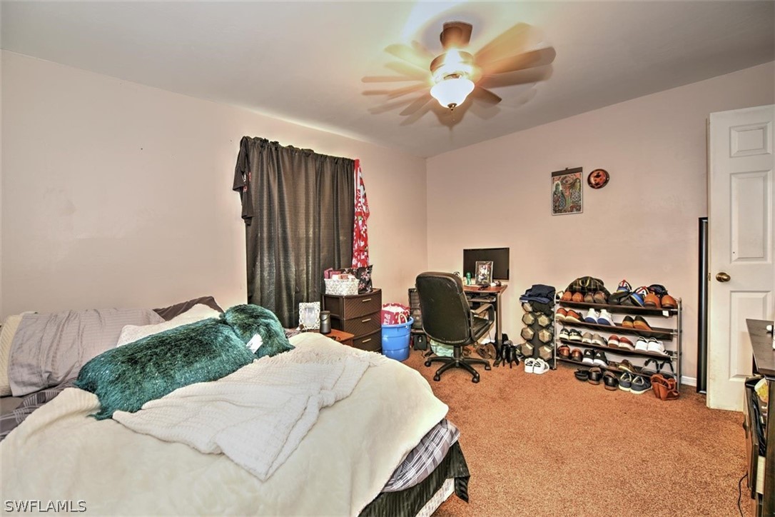 19004 Tangerine Road Fort Myers, FL 33967 - Photo 14 of 26 a bed room with a bed and a chair