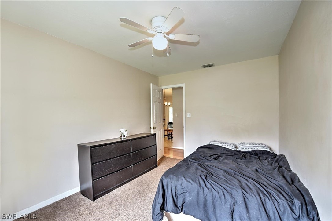 19004 Tangerine Road Fort Myers, FL 33967 - Photo 16 of 26 a bedroom with a bed and a ceiling fan