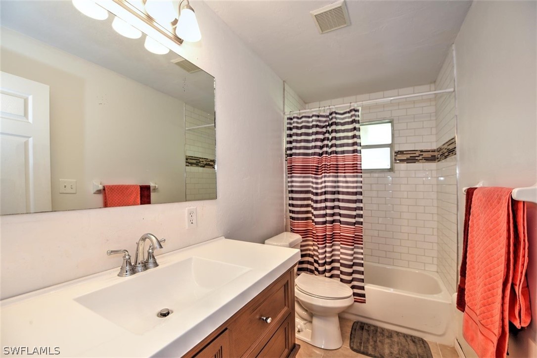 19004 Tangerine Road Fort Myers, FL 33967 - Photo 17 of 26 a bathroom with a sink a toilet and shower