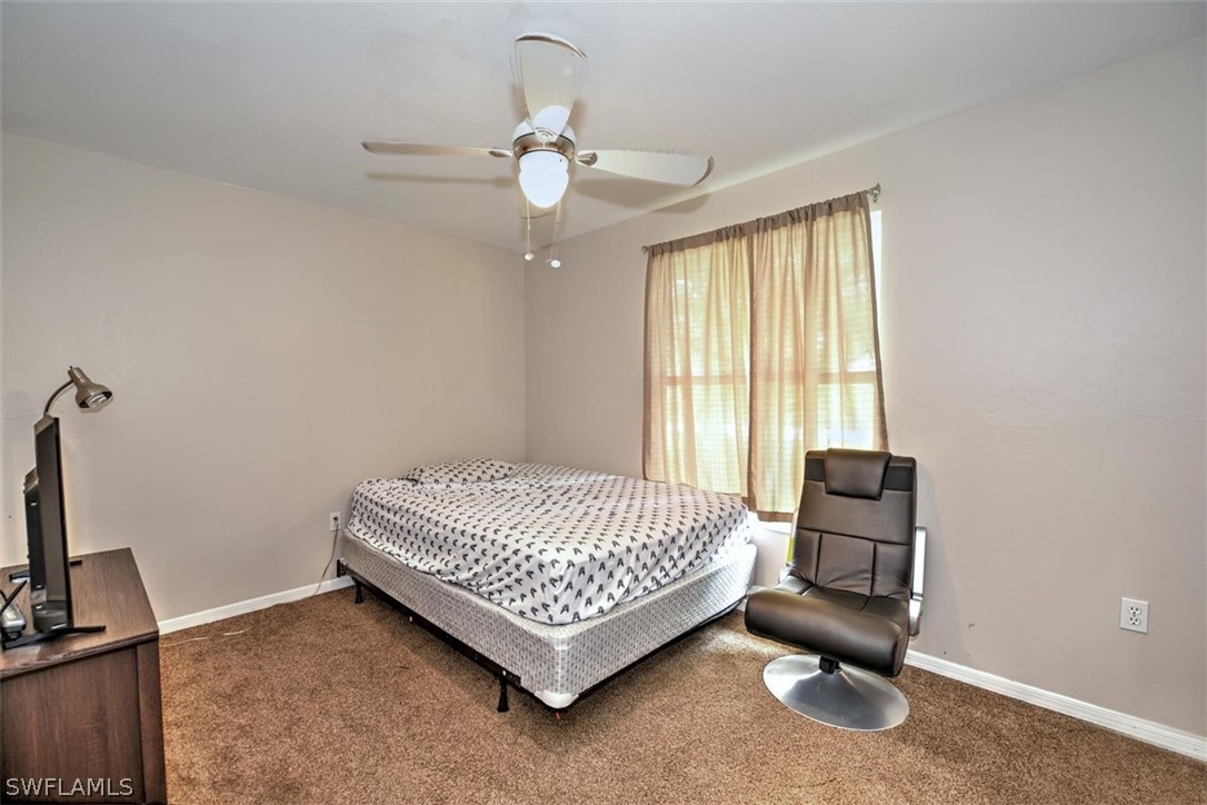 19004 Tangerine Road Fort Myers, FL 33967 - Photo 18 of 26 a bed room with a bed and a window