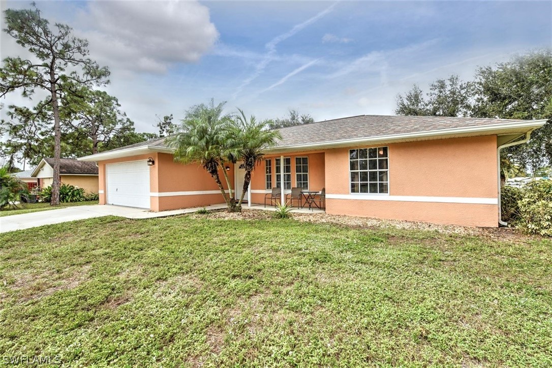 19004 Tangerine Road Fort Myers, FL 33967 - Photo 24 of 26 a front view of a house with a yard and garage