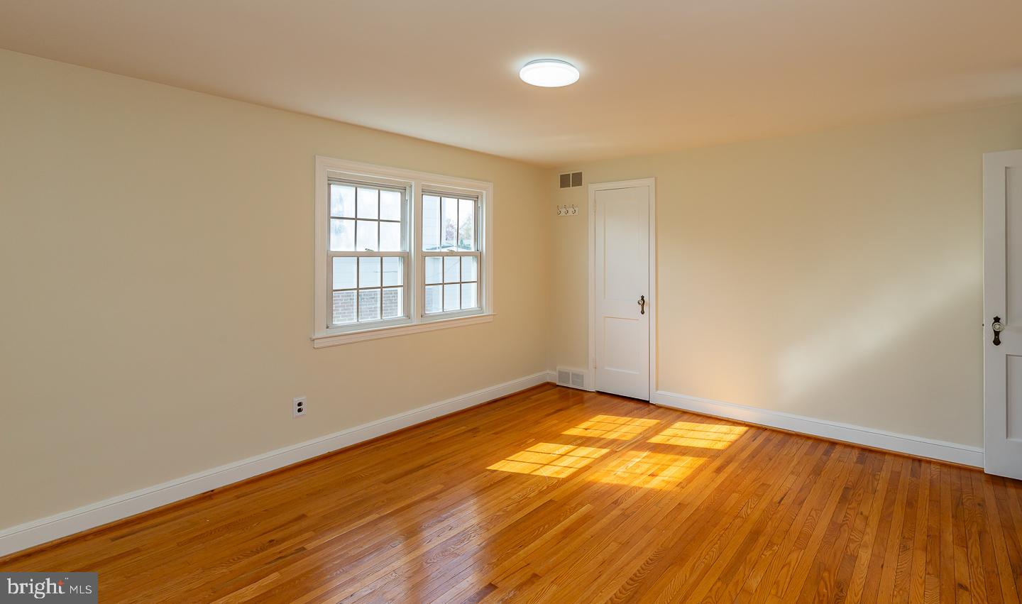 222 Pickwick Road Havertown, PA 19083 - Photo 23 of 39 an empty room with wooden floor and windows