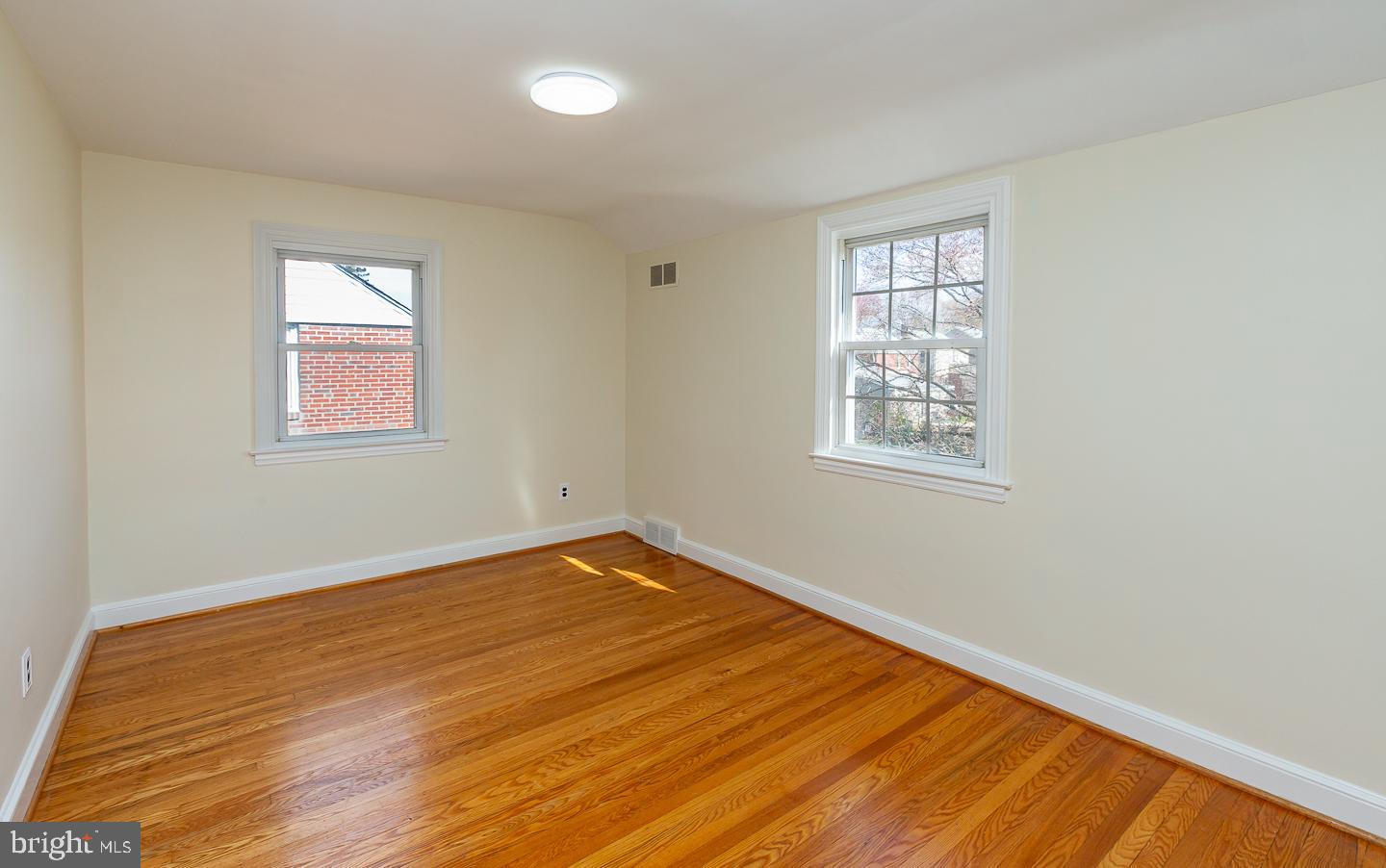 222 Pickwick Road Havertown, PA 19083 - Photo 29 of 39 a view of an empty room with wooden floor and a window
