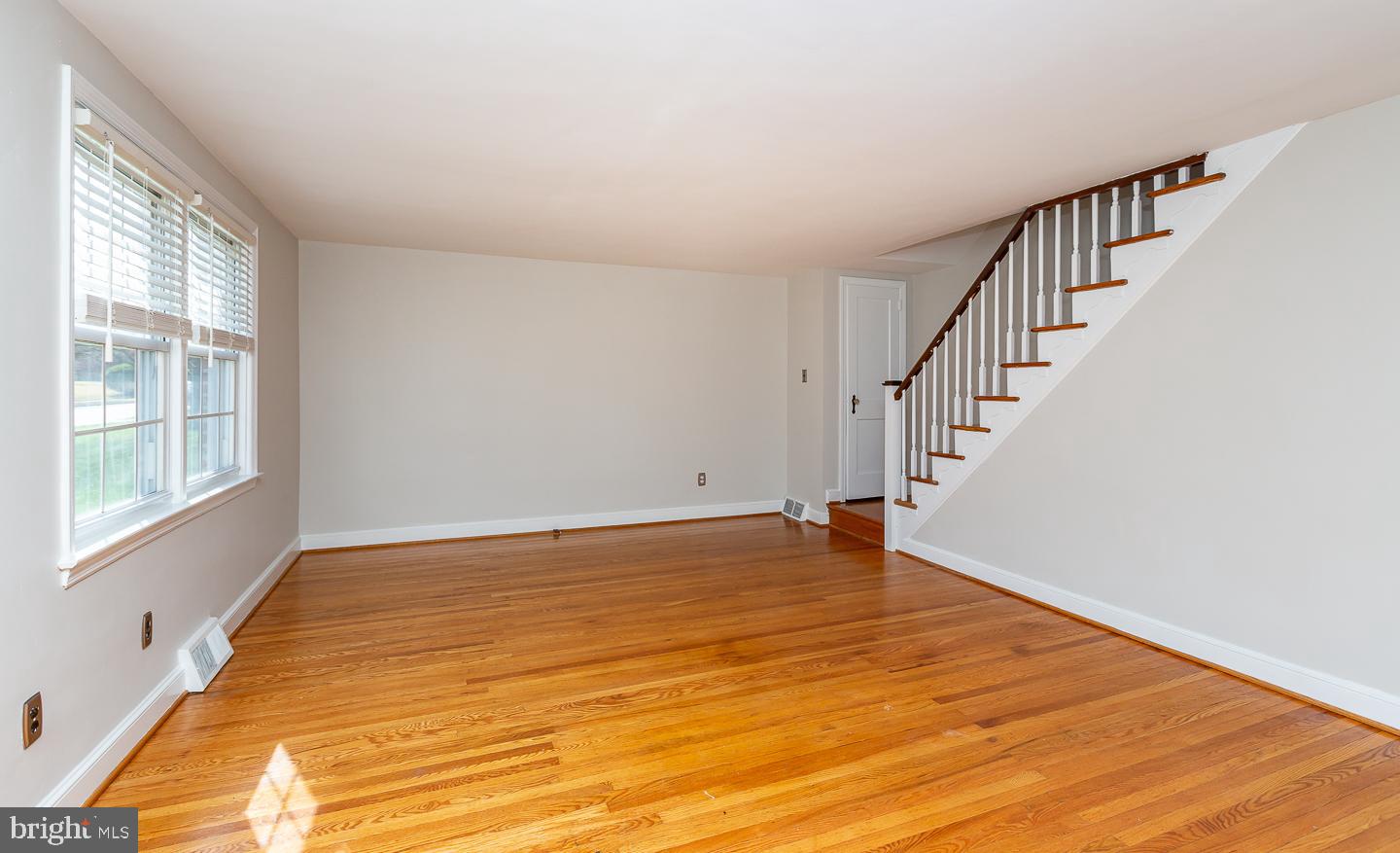 222 Pickwick Road Havertown, PA 19083 - Photo 8 of 39 a view of an empty room with wooden floor and a window