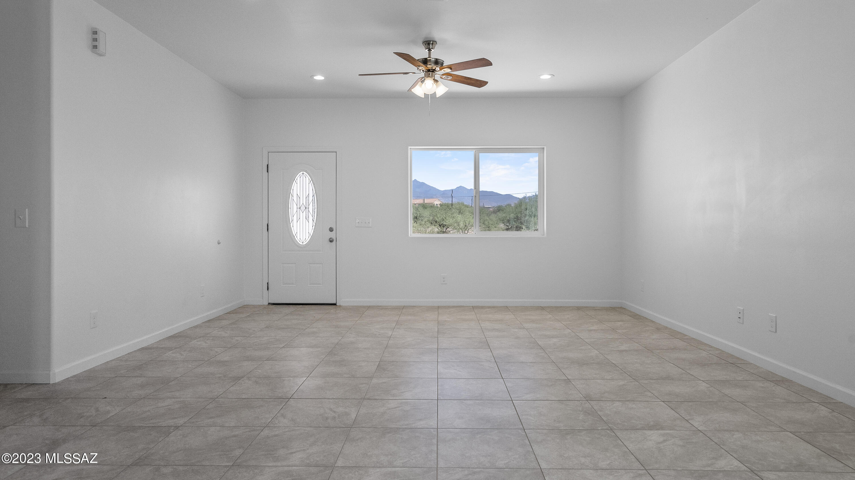 1832 America Court Rio Rico, AZ 85648 - Photo 5 of 19 an empty room with fan and windows