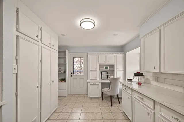a kitchen with white cabinets and white appliances