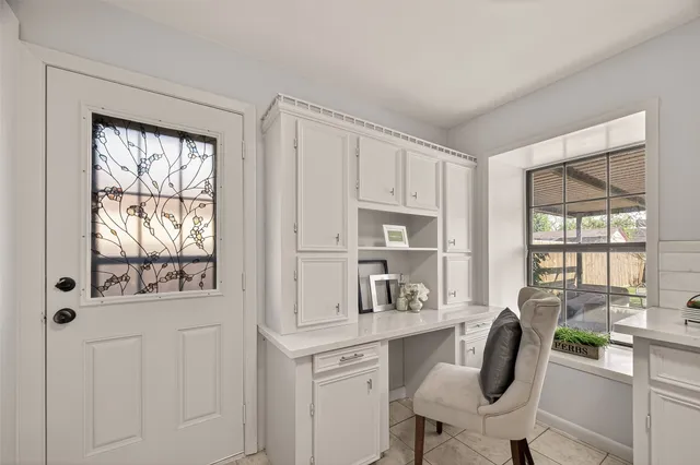 a dining room with furniture and window