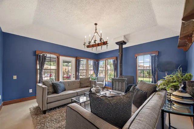 a living room with furniture a chandelier and a large window