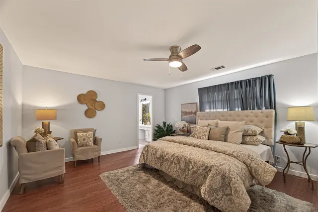 a bedroom with a bed couch and a window